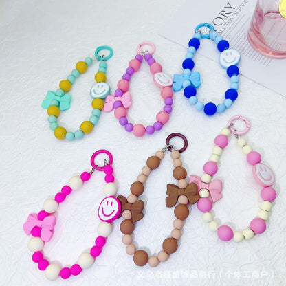 Candy-colored rubber beads smiley face mobile phone pendant bead string keychain live broadcast of the same hanging doll luggage accessories anti-lost