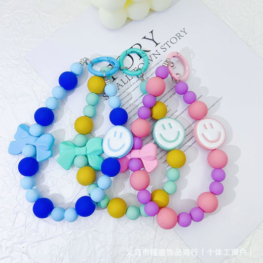 Candy-colored rubber beads smiley face mobile phone pendant bead string keychain live broadcast of the same hanging doll luggage accessories anti-lost