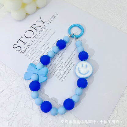Candy-colored rubber beads smiley face mobile phone pendant bead string keychain live broadcast of the same hanging doll luggage accessories anti-lost